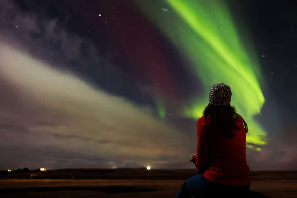 tourist-admiring-magical-aurora-borealis